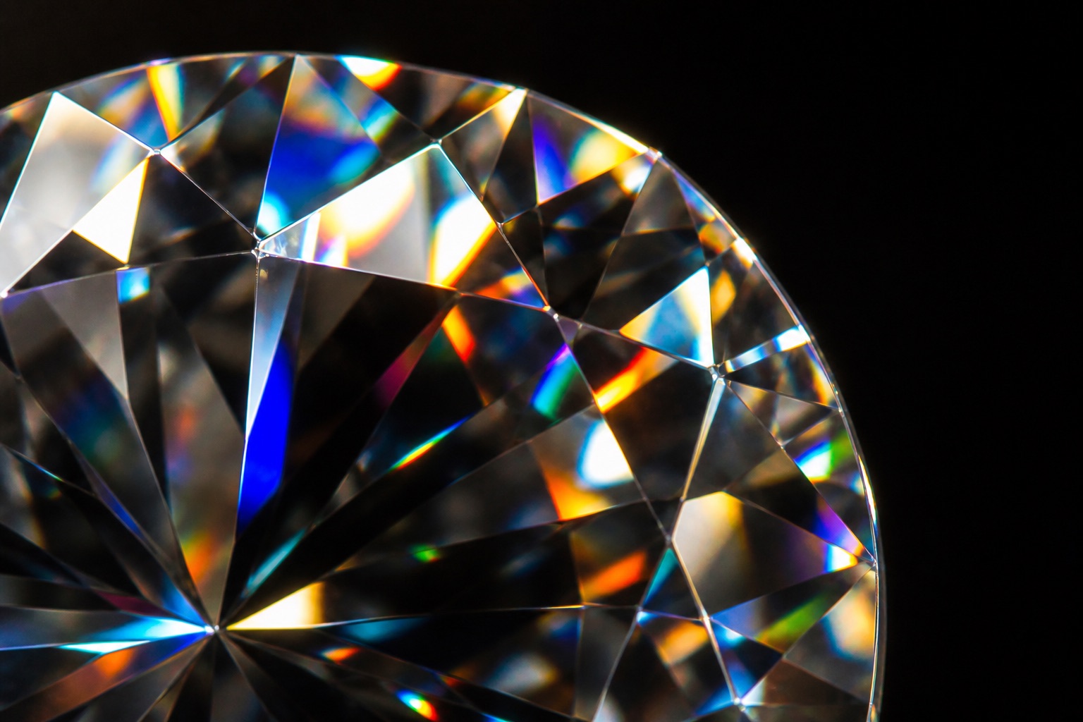 Extreme macro of a faceted stone throwing strong rainbow-colored fire, the light pattern typical of moissanite